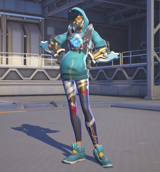 Tracer in her graffiti skin. She wears a light blue hoodie, hood up, dark blue paint-splattered leggings, and light blue sneakers. She's also wearing a mask with goggles and a respirator, and her chronal accelerator, a glowing harness on her chest. It's a very cute outfit.